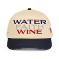 Two-tone trucker hat with Water Faith Wine front graphic; natural crown, dark navy brim.