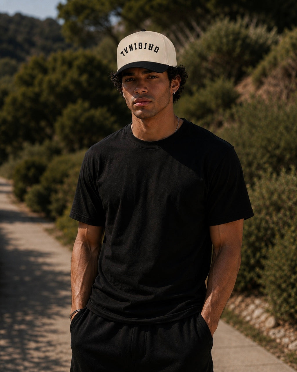 Tan front trucker hat with dark brim and black mesh back, round logo on front