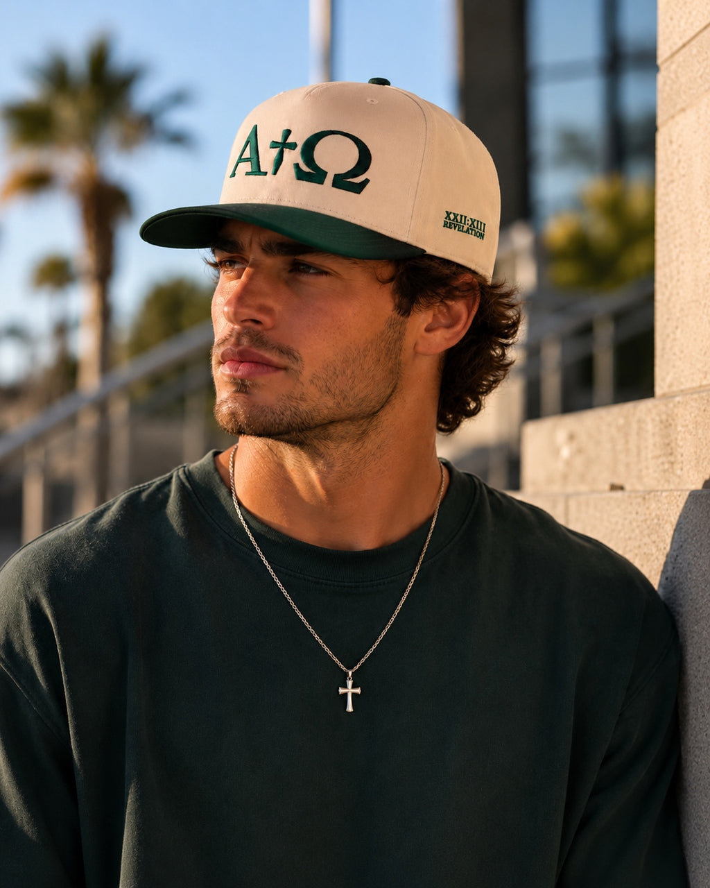 Trucker hat with natural crown, dark green bill, and Alpha Omega logo