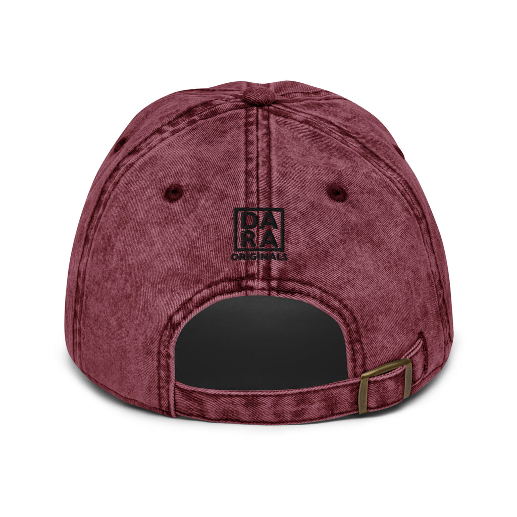 Maroon vintage baseball cap with curved brim, top button, and small front logo patch