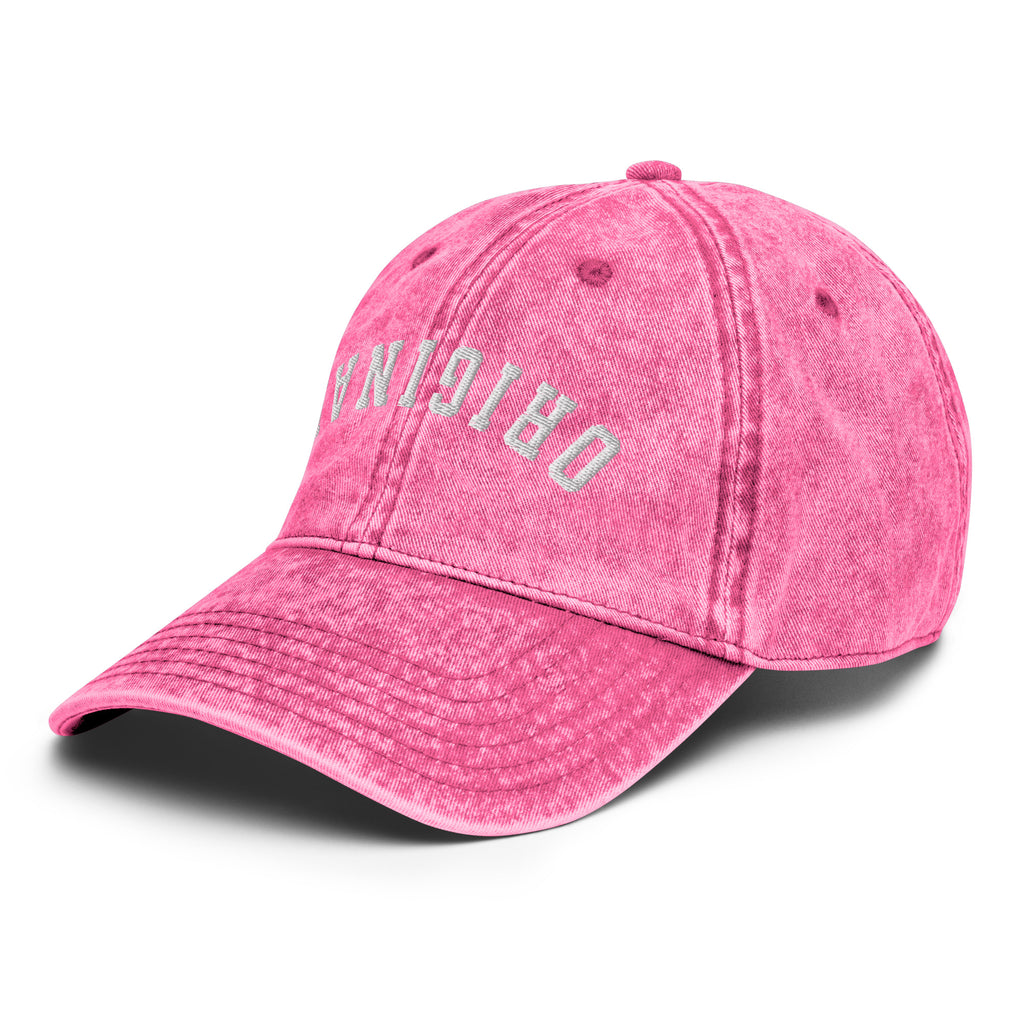 Pink vintage baseball cap with distressed side lettering and curved brim.
