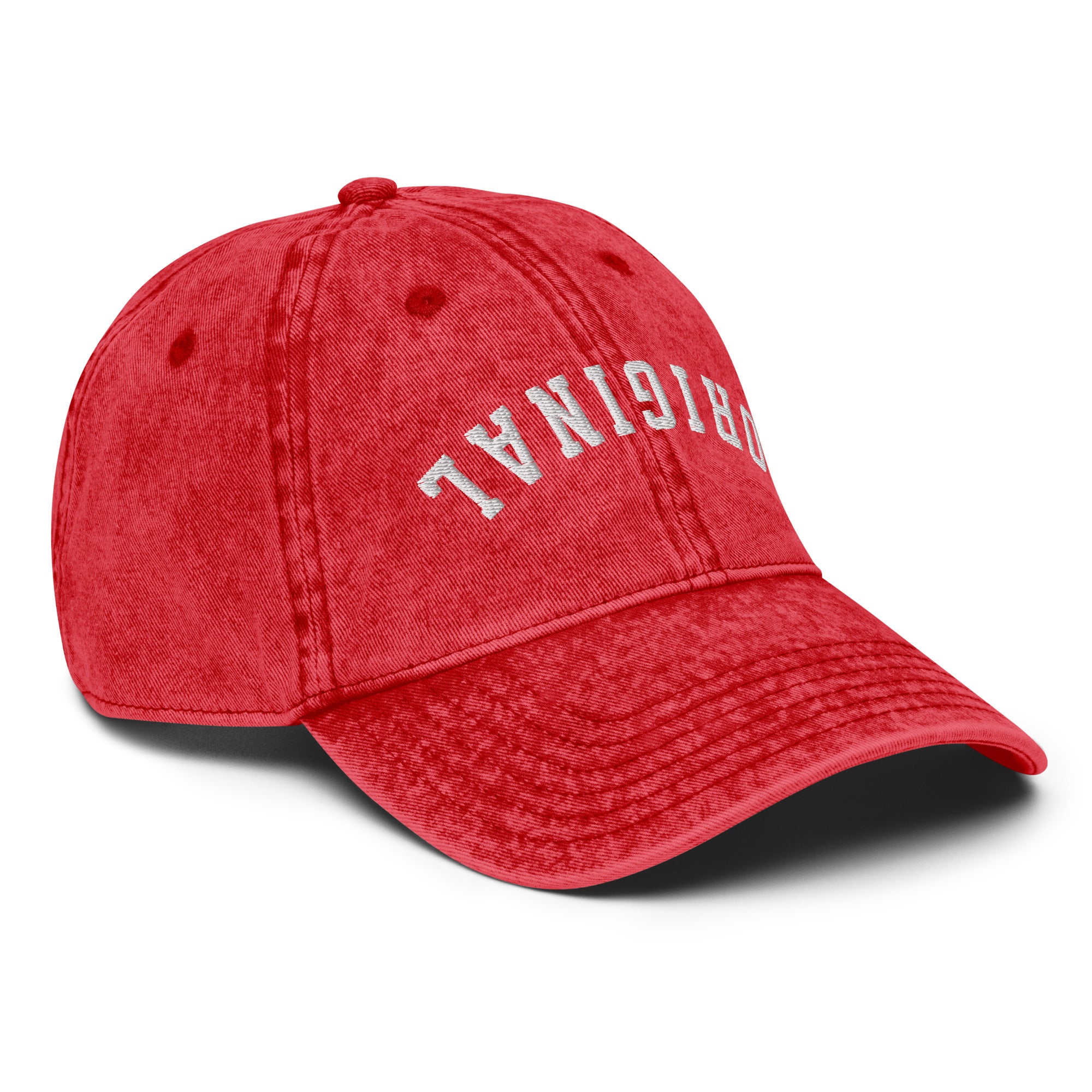Red vintage baseball cap with distressed front lettering on the crown and curved brim.
